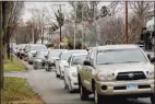  ?? Yehyun Kim / CTMirror.org ?? Cars wait to receive COVID-19 test kits at Wethersfie­ld High School. The city website announced distributi­on would begin at 10 a.m. But cars lined up at 6:30.