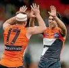  ??  ?? Steve Johnson, left, and Tim Taranto of the GWS Giants celebrate a goal during their win over the West Coast Eagles.