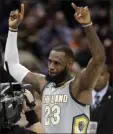  ?? Tony Dejak ?? The Associated Press Cleveland Cavaliers star Lebron James celebrates after making the game-winning basket in overtime against the Minnesota Timberwolv­es on Wednesday in Cleveland.