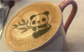  ??  ?? A cup of panda coffee at Panda Café in Chengdu