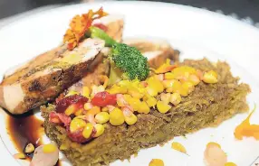  ??  ?? Sweet potato pudding served with an ackee chicken paillard, topped with sautéed vegetables, including sweet corn, broccoli and cranberrie­s.