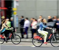  ?? Reuters file ?? Commuters cycle past a bus queue outside Waterloo Station in London, Britain. —