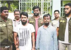  ??  ?? DHAKA: Bangladesh police officials parade suspects Kamal Hossain Sarder (second left) and Kausar Hossain Khan (second right) in Dhaka yesterday, after their arrest in connection with the murder of secular blogger Niloy Chakrabart­i. —AFP