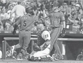  ?? CHRIS SZAGOLA/AP ?? The Diamondbac­ks' Gregor Blanco celebrates his two-run home run with Jeremy Hazelbaker as Phillies catcher Cameron Rupp looks on during the seventh inning Friday in Philadelph­ia.