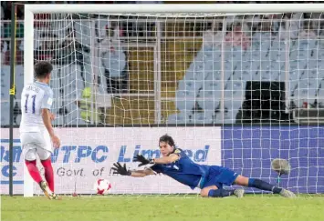  ?? — AP ?? Iraq goalkeeper Ali Ibadi (right) saves a penalty from England’s Jadon Sancho’s in Kolkata on Saturday.