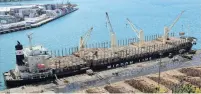  ?? PHOTO:STEPHEN JAQUIERY ?? Cash and carry . . . Logs of councilown­ed City Forest are loaded aboard Bunun Dynasty at the Beach St wharf in Port Chalmers last November.