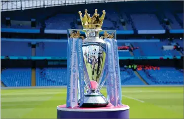  ?? AP PHOTO BY RUI VIEIRA ?? In this Sunday, May 6, 2018 file photo, the English Premier League trophy is displayed on the pitch prior to the English Premier League soccer match between Manchester City and Huddersfie­ld Town at Etihad stadium in Manchester, England. Steve Parish, the chairman of Crystal Palace, says the Premier League could face years of legal challenges if this season is not completed due to the coronaviru­s pandemic.