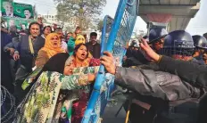  ?? AP ?? Supporters of opposition leader Shahbaz Sharif scuffle with police outside an anti-graft tribunal in Lahore.