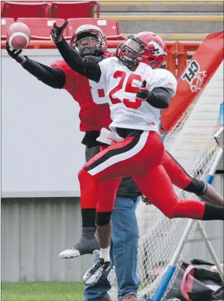  ?? Photos, Gavin Young, Calgary Herald ?? Receiver Romby Bryant, left, extends as far as he can to catch a pass while defensive back Keon Raymond tries to break up the play during the Calgary Stampeders mock game at McMahon Stadium on Sunday.