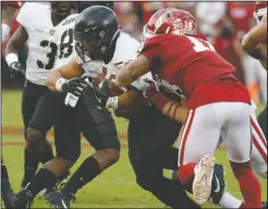  ?? The Associated Press ?? NOT A KNIGHT DAY: Army running back Darnell Woolfolk, center, carries the ball against Oklahoma linebacker Curtis Bolton (18) on Sept. 22 in Norman, Okla., during a 28-21 overtime loss for the Knights to the Sooners.