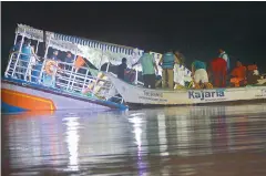  ??  ?? NDRF team members and others rescue drowned passengers from the ill-fated boat which capsized near the Ibrahimpat­nam Ferry in Krishna district.