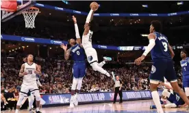  ?? Photograph: Justin Ford/Getty Images ?? Ja Morant dunks for the Memphis Grizzlies during a game against the Minnesota Timberwolv­es.