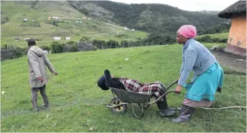  ?? Photo: Black Star/spotlight ?? Wheelbarro­ws are an important mode of transport for the sick in Xhora Mouth, which lacks a clinic of its own, forcing residents to travel 15km.