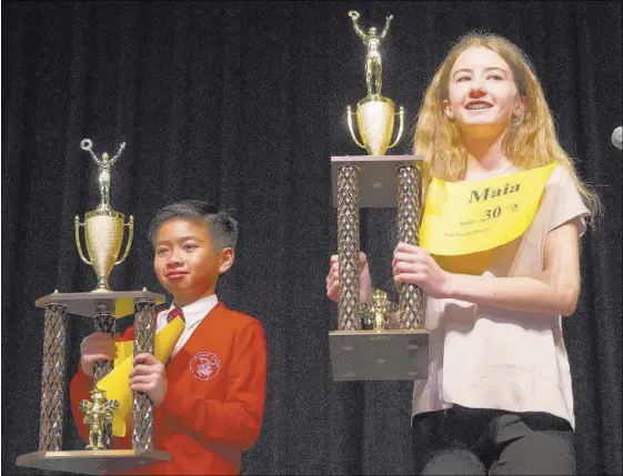  ?? ERIK VERDUZCO/LAS VEGAS REVIEW-JOURNAL @ERIK_VERDUZCO ?? Nevada State Spelling Bee contest runner-up Aarron Mangio, 11, and winner Maia Marshall, 13, are seen Saturday at Bishop Gorman High School. Maia won on the word “samurai,” and will go to Washington, D.C., for the Scripps National Spelling Bee, which...