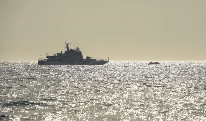  ??  ?? A Turkish coast guard vessel approaches a life raft carrying migrants in the Aegean Sea, between Turkey and Greece, Sept. 12, 2020.