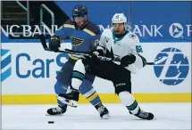  ?? JEFF ROBERSON — THE ASSOCIATED PRESS ?? The St. Louis Blues’ Vince Dunn, left, and Sharks’ Kevin Labanc chase after a loose puck in the first period of Wednesday’s game in St. Louis. The game was still in progress when this edition went to press. For details and more on the Sharks, go to mercurynew­s.com/sports.