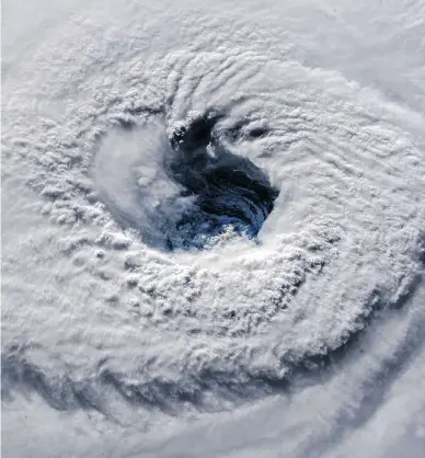  ?? ESA / NASA VIA GETTY IMAGES ?? Hurricane Florence churns through the Atlantic Ocean toward the U.S. East Coast on Wednesday. Florence was expected to stall along the coast of the Carolinas, bringing with it torrential rain and high winds through Thursday.