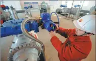  ?? GUO JUNFENG / FOR CHINA DAILY ?? A technician adjusts a valve on a China-Russia oil pipeline in Daqing, Heilongjia­ng province.