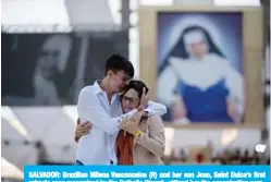  ??  ?? SALVADOR: Brazilian Milena Vasconcelo­s (R) and her son Joao, Saint Dulce’s first miracle case recognized by the Catholic Church, atttend her the canonizati­on ceremony at the Fonte Nova Arena Stadium. —AFP