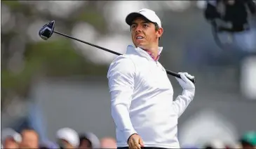  ?? PHOTOS BY CURTIS COMPTON / CCOMPTON@AJC.COM ?? Rory McIlroy reacts to hooking his tee shot into the woods on the first hole during the final round of the Masters at Augusta National Golf Club on Sunday.