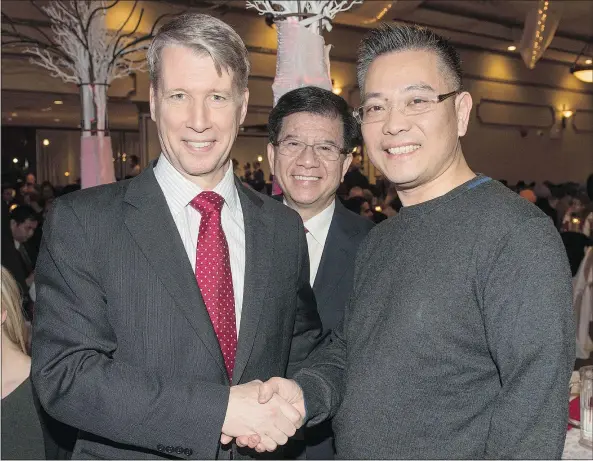  ?? — SILVESTER LAW ?? Michael Ching, right, shakes hands with federal Liberal candidate Andrew Leslie, left, as former Richmond MP Raymond Chan looks on at a party fundraisin­g event in Vancouver in January.