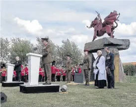  ??  ?? &gt; Brigadier Alan Richmond, Head of the Army in Wales, reads the Exhortatio­n at the Welsh Memorial in Flanders