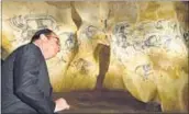  ??  ?? French President Hollande looks at cave paintings in a replica of the Chauvet Cave during his visit to Vallon Pont d’Arc, on Friday. AFP