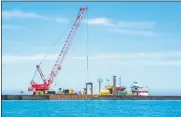  ?? U.S. ARMY CORPS OF ENGINEERS ?? The U.S. Army Corps of Engineers Buffalo District announced repairs were complete at the Lorain Harbor breakwater. Contractor Great Lakes Dock and Materials LLC is seen working on the breakwater on June 29.