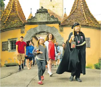  ?? DOMINIC ARIZONA BONUCCELLI, RICK STEVES’ EUROPE ?? The night watchman leads visitors through Rothenburg, Germany’s best-preserved medieval town, every night during tourist season.