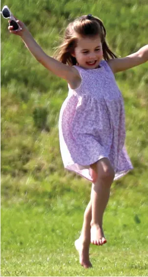  ??  ?? Jumping for joy: Princess Charlotte skipping merrily at a polo match last month in a pose remarkably like her grandmothe­r, Diana, at St Tropez in the summer of 1997