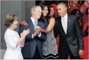  ?? PICTURE: REUTERS ?? US First Lady Michelle Obama hugs former US president George W Bush as she arrives with President Barack Obama and former first lady, Laura Bush, for the dedication of the Smithsonia­n’s National Museum of African-American History and Culture in...