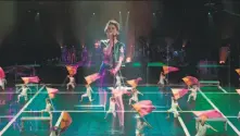  ?? Oscillosco­pe Films ?? Singer St. Vincent performs with one of the 10 color guards in a concert documentar­y with impressive choreograp­hy.