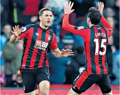  ??  ?? Fighting back: Dan Gosling celebrates with Adam Smith after scoring the equaliser