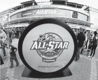  ??  ?? A giant hockey puck is part of the Thunder Alley area at the NHL All-Star Fan Fest outside Amalie Arena in Tampa, Florida. On Sunday, the All-Star game starts at 12:30 p.m. Pacific.