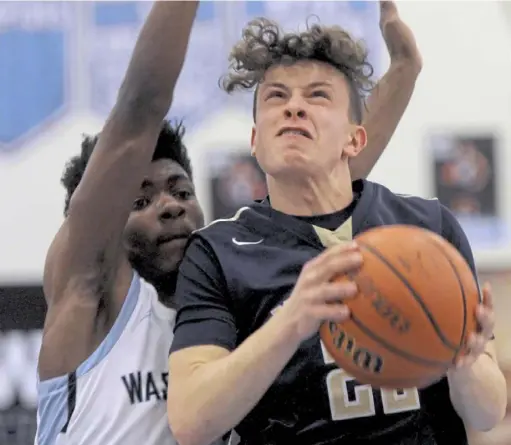  ?? Pam Panchak/Post-Gazette ?? McGuffey’s Nate Witkowsky drives around Washington’s Zahmere Robinson Friday night in Washington.