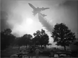  ?? ASSOCIATED PRESS ?? A 747 GLOBAL AIRTANKER in Lakeport, Calif. makes a drop in front of advancing flames from a wildfire Thursday