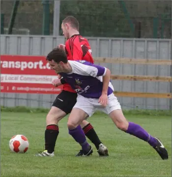  ??  ?? Colin O’Brien of the Wexford Football League challenges Eoin Sherlock of the United Churches Football League during their recent game.