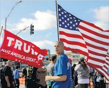  ?? Jay L. Clendenin Los Angeles Times ?? AN “AMERICA FIRST!” rally against illegal immigratio­n drew about 2,500 protesters and counter-protesters to Laguna Beach. As it wound down, police escorted the “America First!” group from the area.