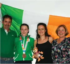  ??  ?? Dearbhla Rooney of Team Ireland, from Manorhamil­ton, with her father Padraig, Bronadh and her mother Geraldine and her bronze medal at the World Youth Olympics. Pic: Eóin Noonan/Sportsfile.