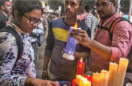  ?? Photo: Xinhua ?? People select electric candles for Diwali in Kolkata, India, on October 22, 2019. Diwali is a Hindu festival of lights which is celebrated all over India.