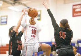  ?? THE’N PHAM/STAFF ?? Princess Anne’s Aziaha James, center, drives to the basket against Salem’s Riley Sheridan, left, and Amaris Felton on Saturday. The Cavaliers won 75-43.