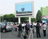  ?? Jon Chol Jin / AP Photo ?? People watch a news broadcast on the launch of Pukguksong-2 on a big screen in Pyongyang yesterday.