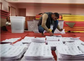  ?? Photo: VCG ?? An election commission staffer separates ballots ready for tallying a day after the general election in Kathmandu, Nepal, on November 21, 2022.