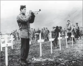  ?? AP PHOTO, FILE ?? In this Aug. 1943 file photo, a bugler sounds taps during a memorial service while a group of G.I.s visit the graves of comrades who fell in the reconquest of Attu Island, part of the Aleutian Islands of Alaska. Wednesday, May 30, 2018 will mark the...
