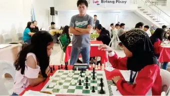  ??  ?? BEST CHESS PERFORMER. Cagayan de Oro's Ruelle "Tawing" Canino, at left, opposite Rhynna Mamontuan of Mati City, virtually wins her second Batang Pinoy gold in chess after a perfect 6 of 6 performanc­e in standard event yesterday. (Lynde Salgados)