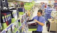 ?? Hearst Connecticu­t Media file photo ?? Joe Cimmino, executive assistant manager at the Walgreens store on York Street in New Haven stocks back-to-school items in July 2018. Stamford-based Synchrony announced Monday that it will be issuing two wellness-focused credit cards for Walgreens.