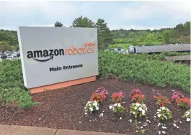  ??  ?? Above, Amazon’s Robotics group headquarte­rs in North Reading, Mass. The building was the original home of Kiva Systems, the warehouse robotics company that Amazon purchased in 2012. It is one of four Amazon offices around Boston.