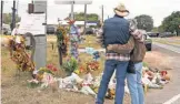  ?? COURTNEY SACCO/ USA TODAY NETWORK ?? People stop Wednesday at a memorial near the Sutherland Springs shooting in Texas.