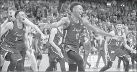  ?? David Goldman Associated Press ?? LOYOLA CHICAGO players storm the court after beating Kansas State in the South Regional final. It is the school’s first time in NCAA tournament since 1985.