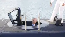  ?? (Baz Ratner/Reuters) ?? PRIME MINISTER Benjamin Netanyahu climbs out the Dolphin-class submarine ‘Rahav’ after it arrived in Haifa in January.